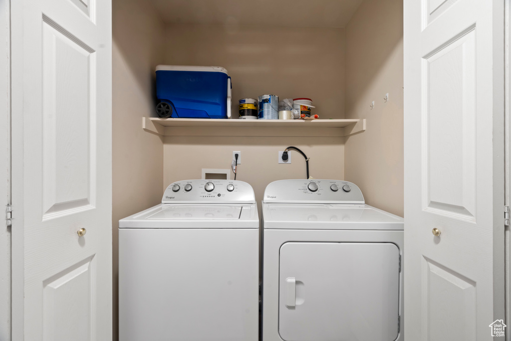 Laundry area with electric dryer hookup, washer hookup, and washing machine and clothes dryer