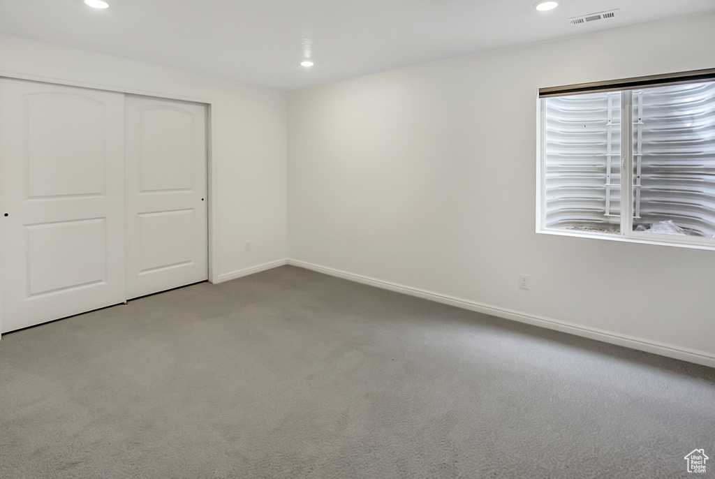 Interior space featuring dark carpet and a closet