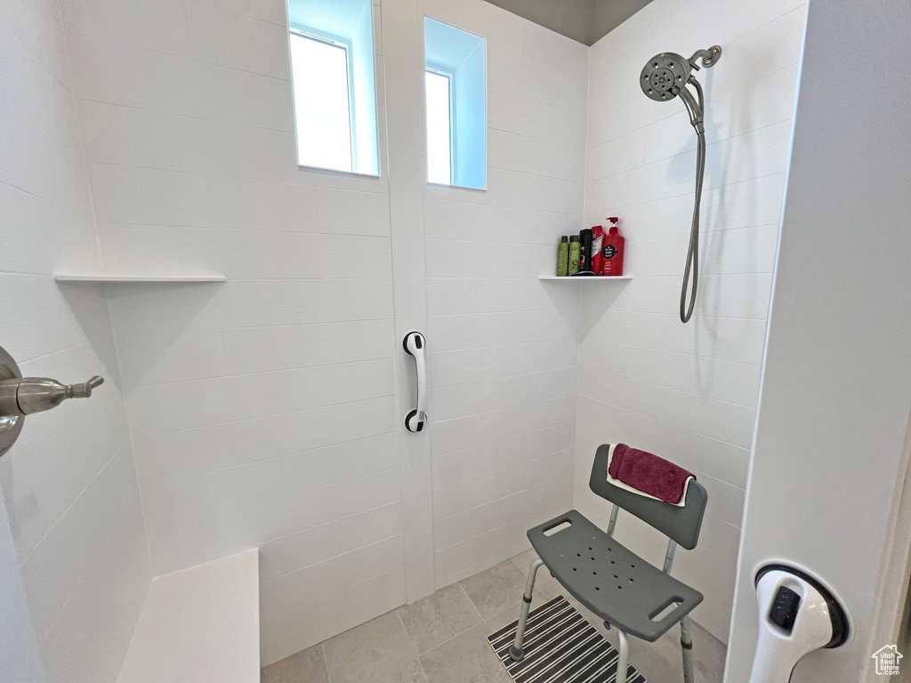 Bathroom featuring a tile shower and tile flooring