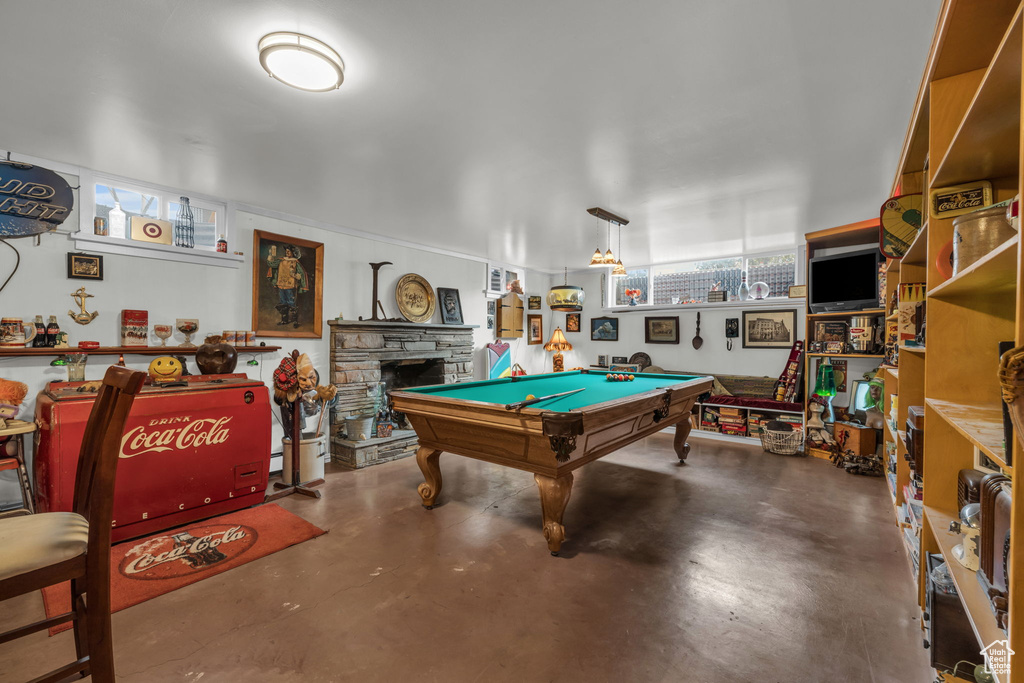 Game room featuring pool table and a fireplace