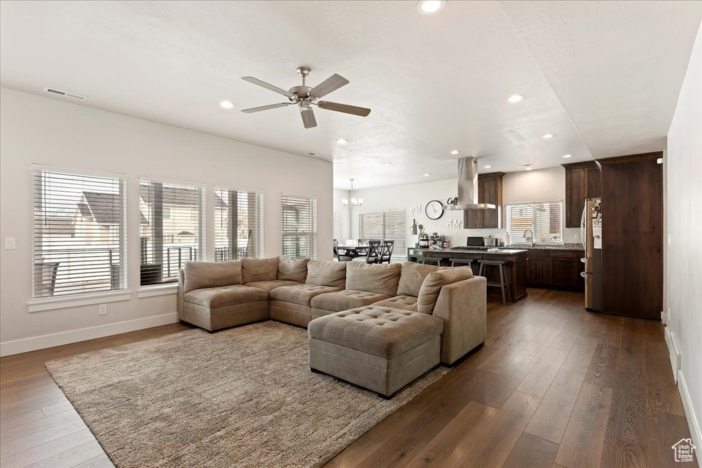Living room with hardwood / wood-style floors, a healthy amount of sunlight, ceiling fan, and sink