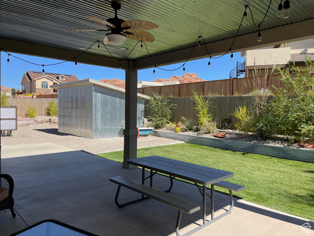 View of patio / terrace with a storage shed and ceiling fan