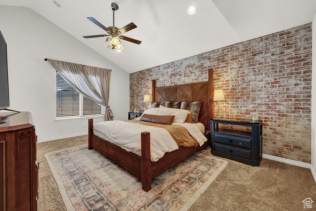 Carpeted bedroom featuring brick wall, ceiling fan, and lofted ceiling