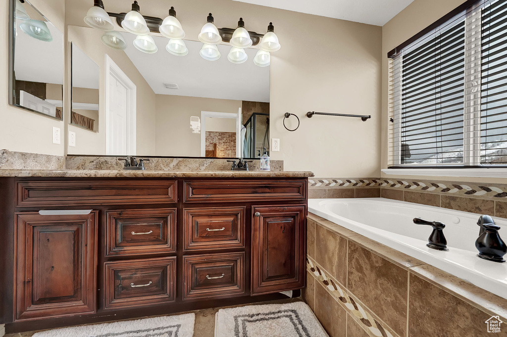 Bathroom with double sink vanity and a relaxing tiled bath