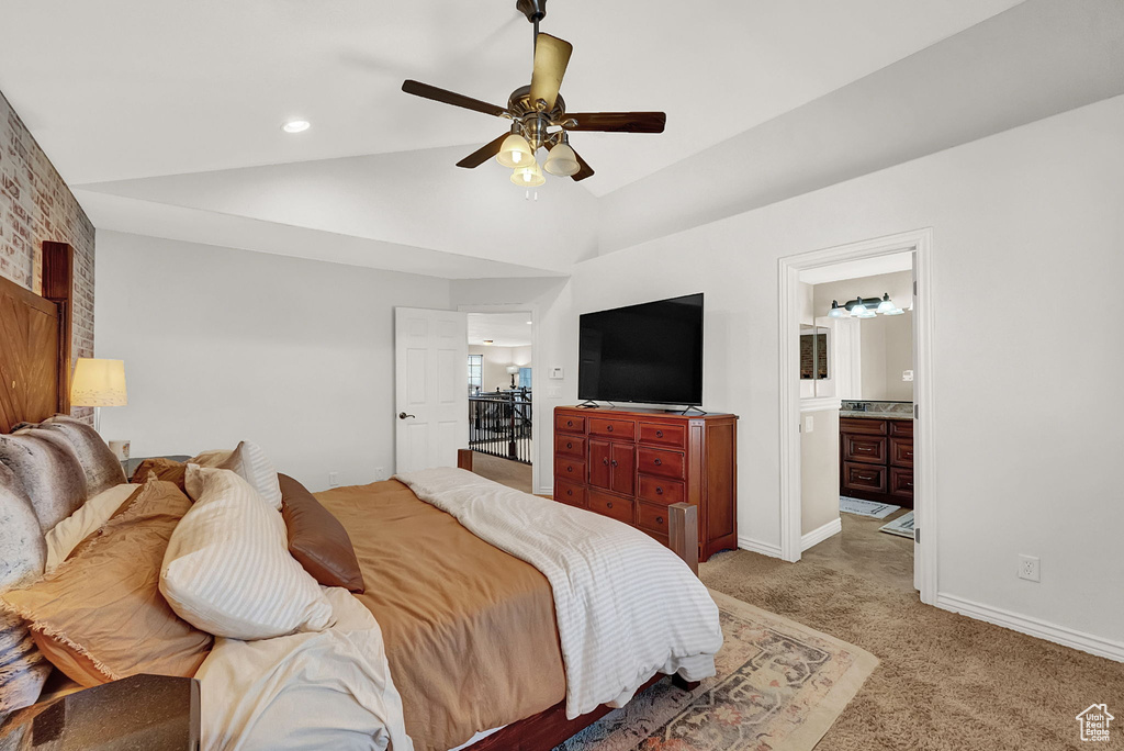 Carpeted bedroom with high vaulted ceiling, ceiling fan, and connected bathroom