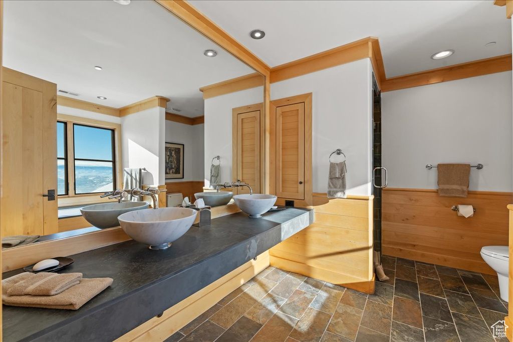 Bathroom with dual sinks, tile floors, oversized vanity, and toilet