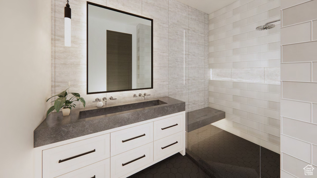 Bathroom with large vanity, tile walls, and tile flooring