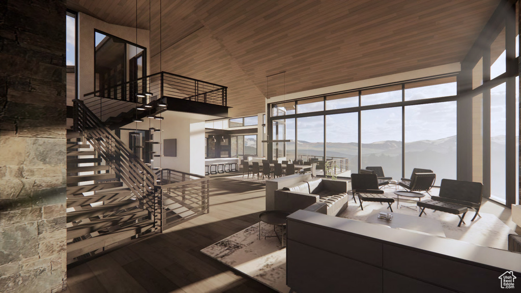 Living room featuring plenty of natural light, dark wood-type flooring, a mountain view, a high ceiling, and wood ceiling