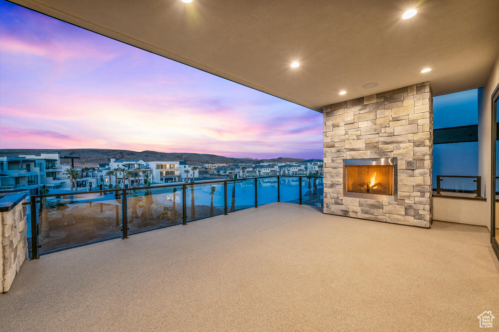 Balcony at dusk with a fireplace