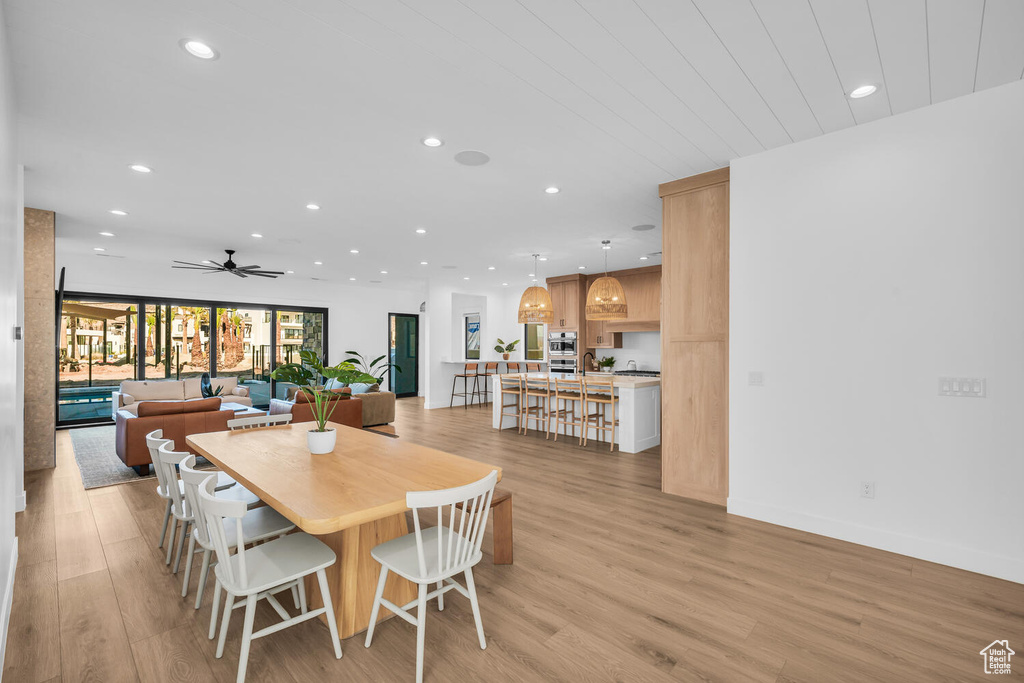 Dining space featuring light wood-type flooring and ceiling fan