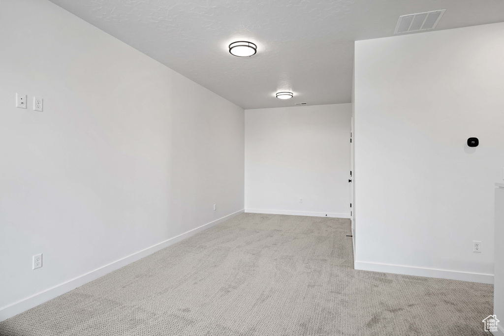 Spare room featuring light colored carpet