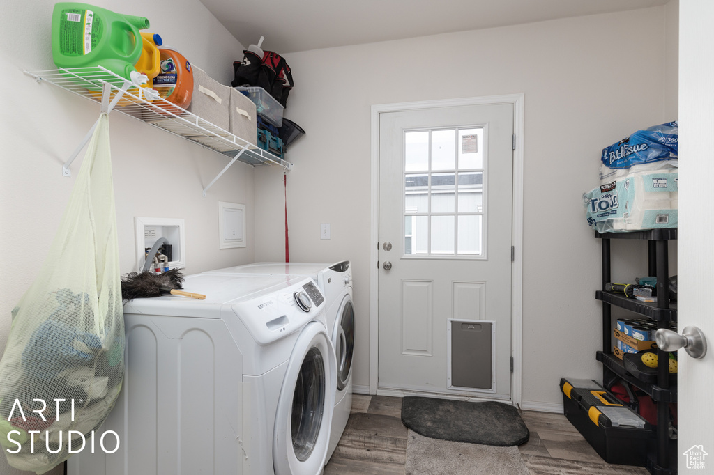 Laundry area featuring hardwood / wood-style flooring, separate washer and dryer, and hookup for a washing machine