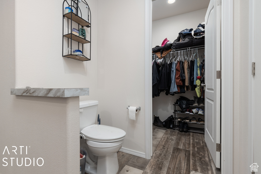 Bathroom featuring hardwood / wood-style flooring and toilet