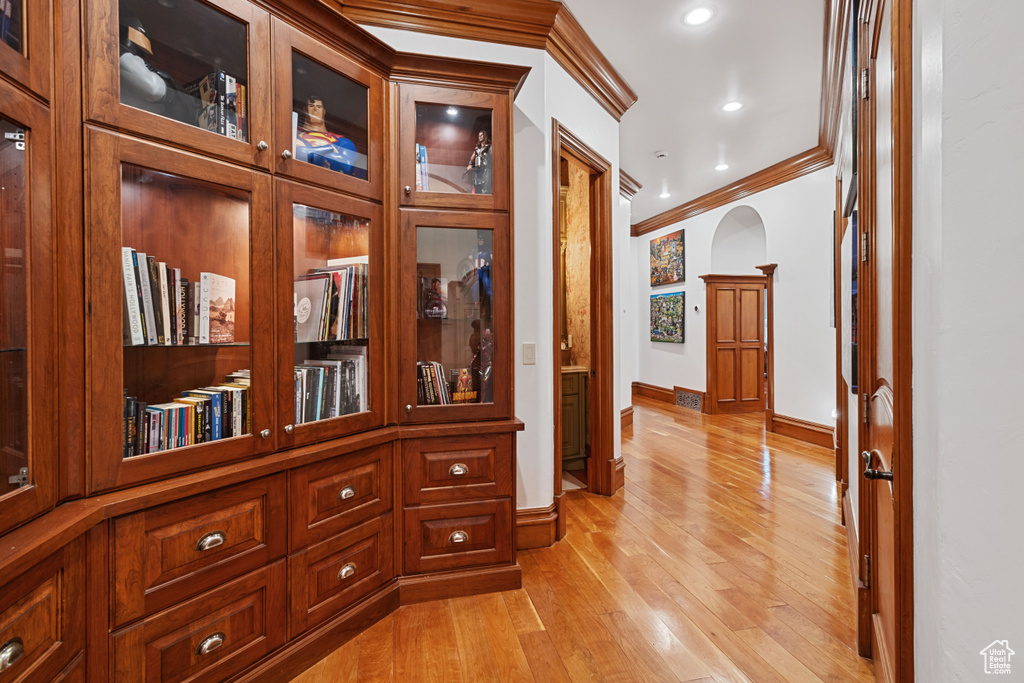 Corridor featuring light hardwood / wood-style floors and ornamental molding
