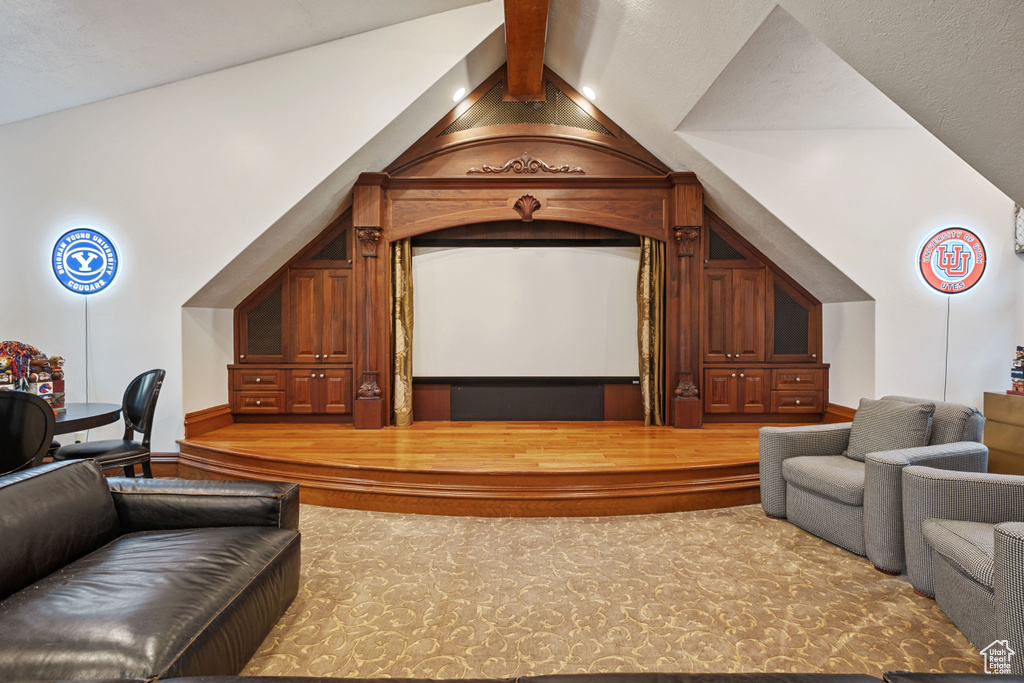 Cinema room featuring lofted ceiling with beams