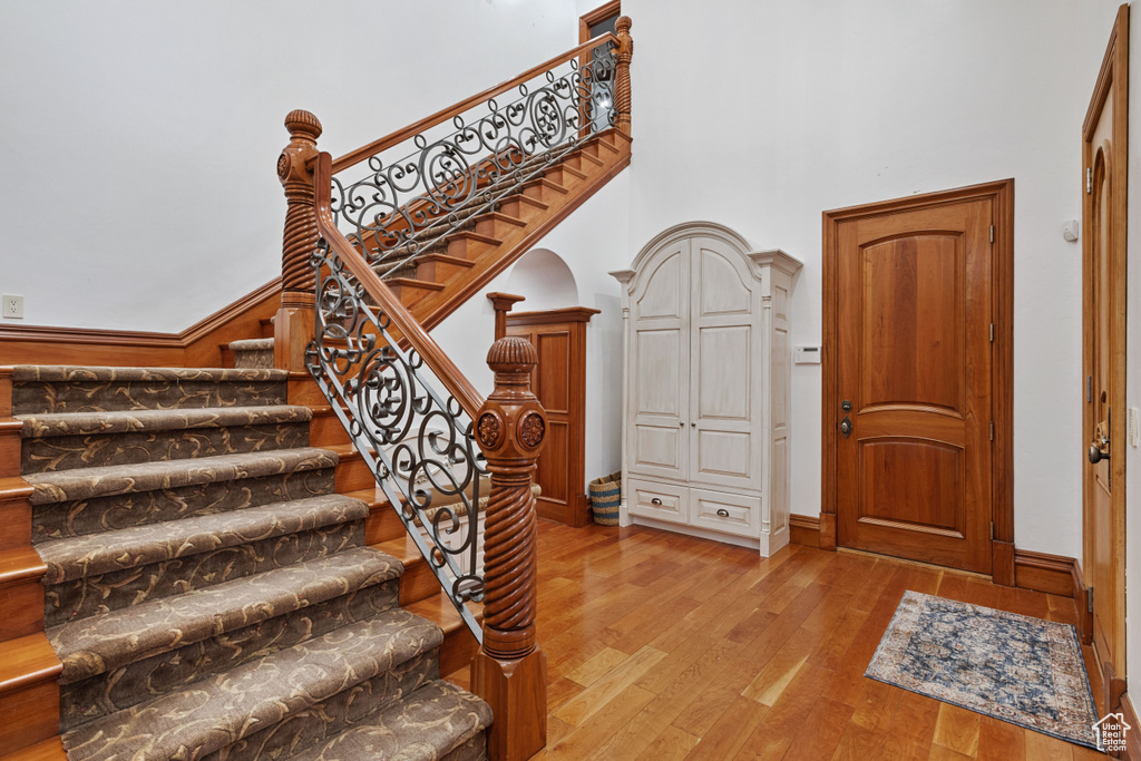 Entryway featuring light hardwood / wood-style flooring and a towering ceiling