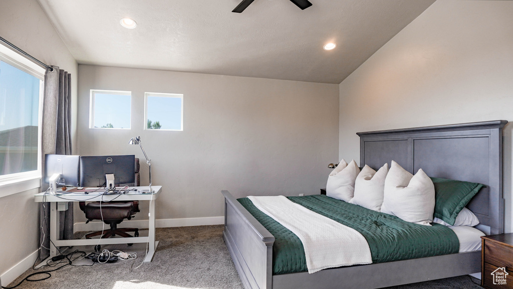 Bedroom with vaulted ceiling, ceiling fan, and light carpet