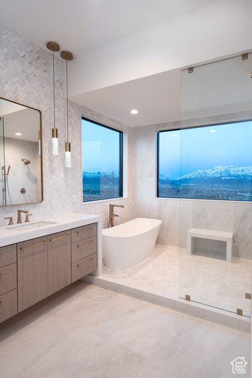 Bathroom featuring tile flooring, backsplash, tile walls, and vanity