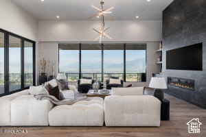 Living room featuring hardwood / wood-style flooring and a notable chandelier