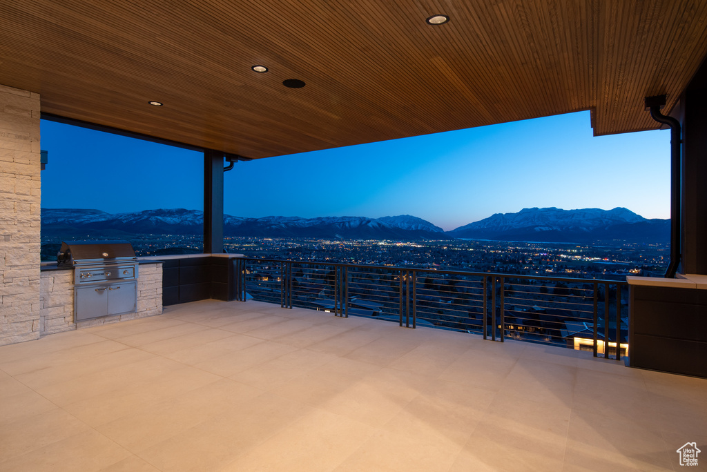 View of patio / terrace with a mountain view, a balcony, area for grilling, and an outdoor kitchen