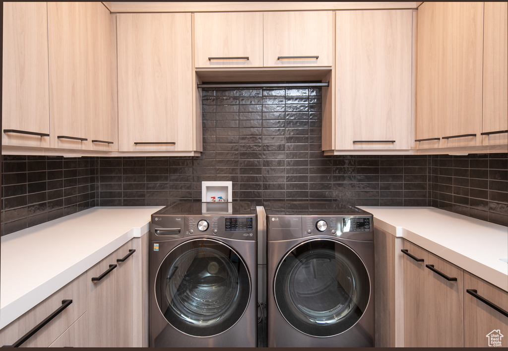 Laundry area with independent washer and dryer, cabinets, and hookup for a washing machine