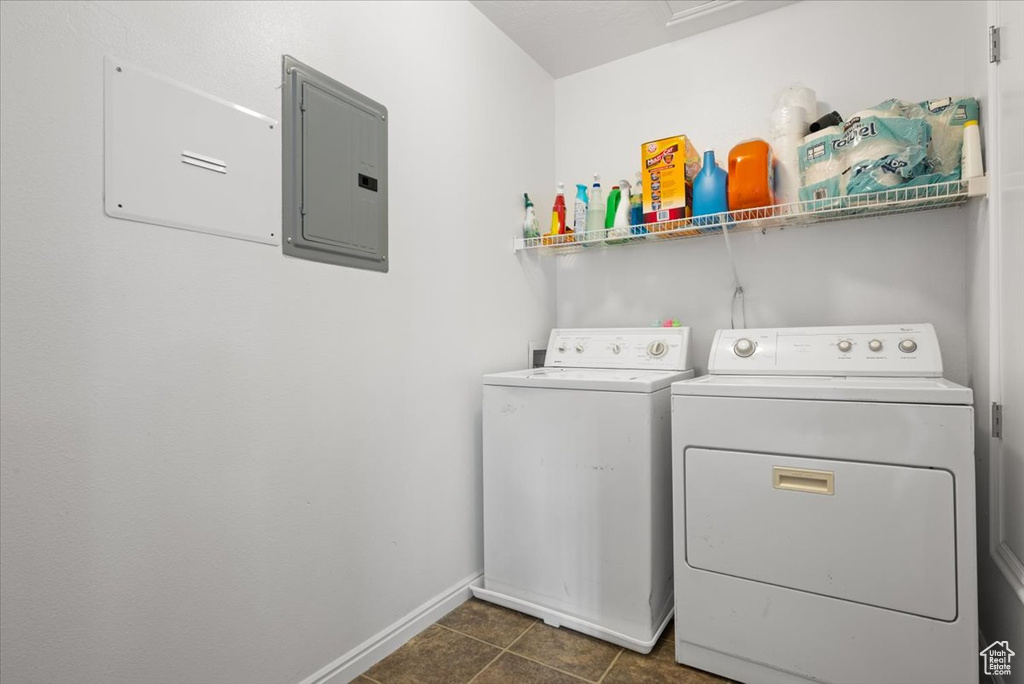 Washroom featuring washer and dryer and dark tile floors