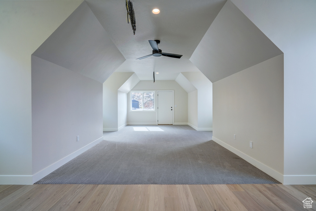 Bonus room featuring light hardwood / wood-style flooring, vaulted ceiling, and ceiling fan