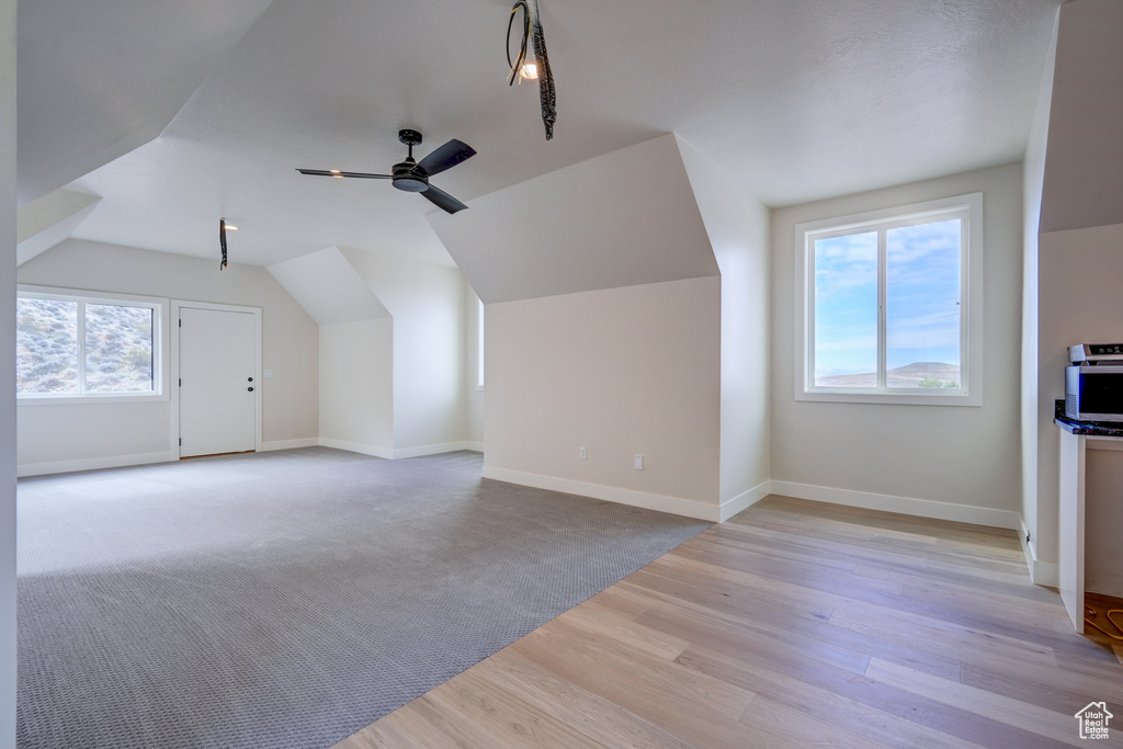 Bonus room featuring lofted ceiling, ceiling fan, and light colored carpet