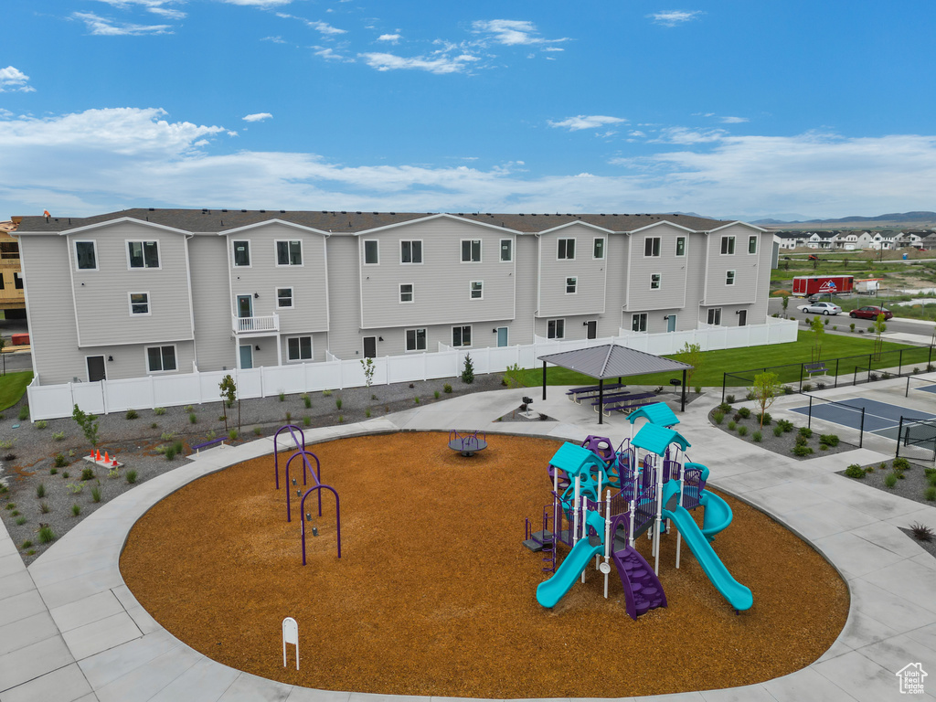 Exterior space with a lawn and a playground