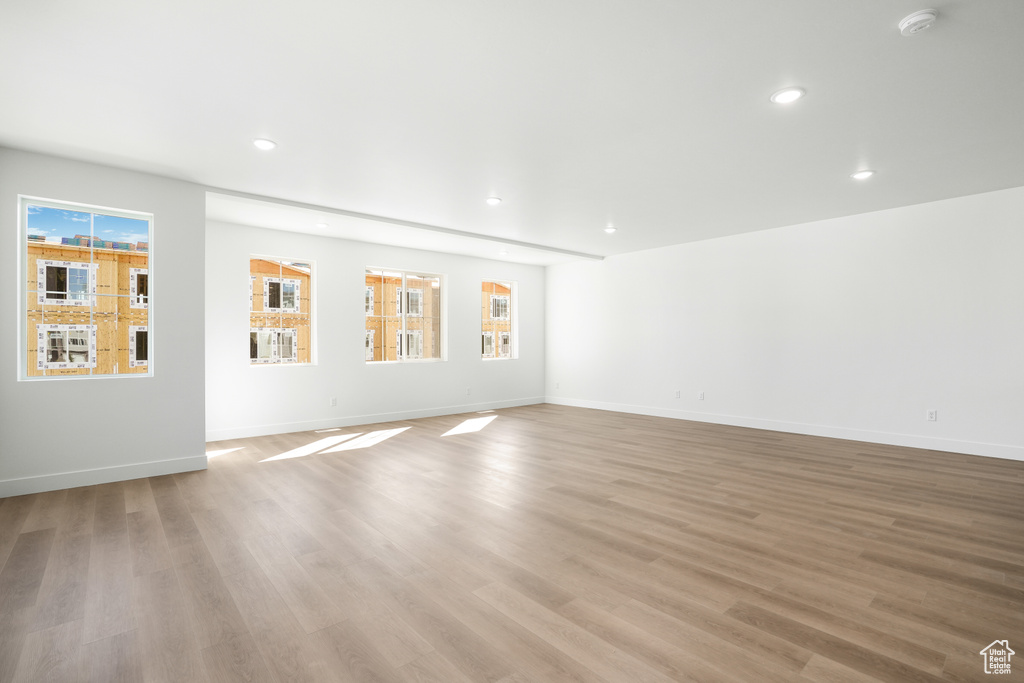 Empty room featuring light hardwood / wood-style floors and plenty of natural light