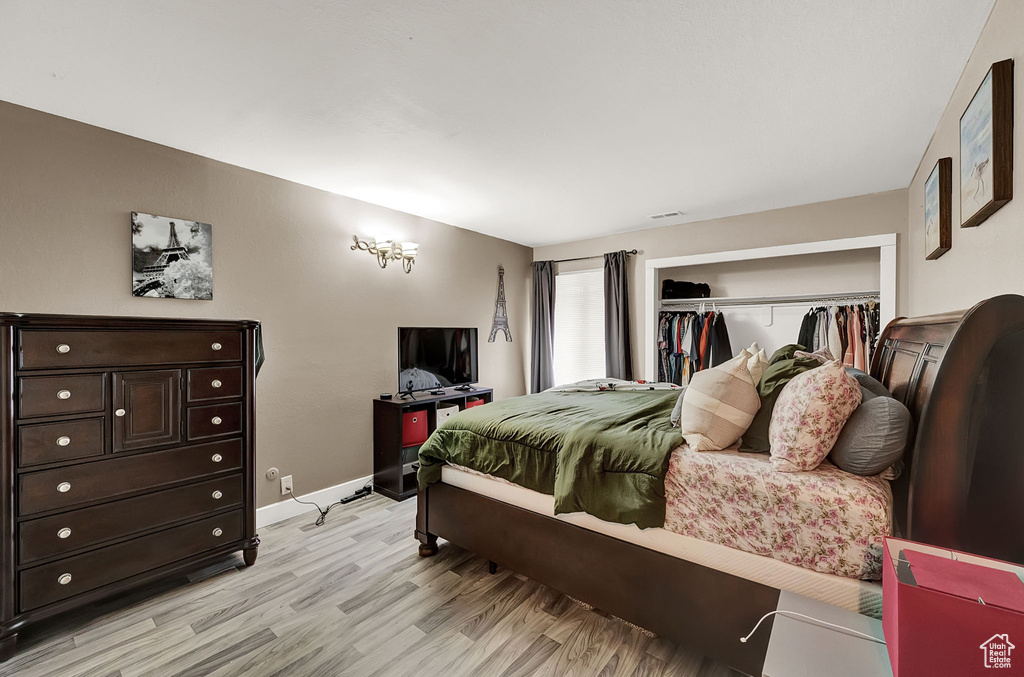 Bedroom featuring light hardwood / wood-style floors and a closet