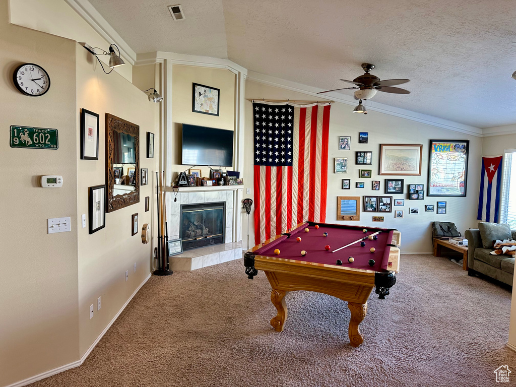 Rec room with a fireplace, billiards, crown molding, lofted ceiling, and ceiling fan