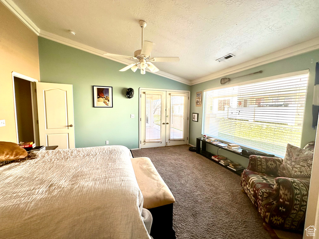 Bedroom featuring ceiling fan, vaulted ceiling, access to exterior, french doors, and dark carpet
