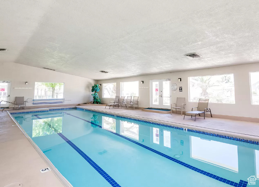 View of swimming pool with french doors