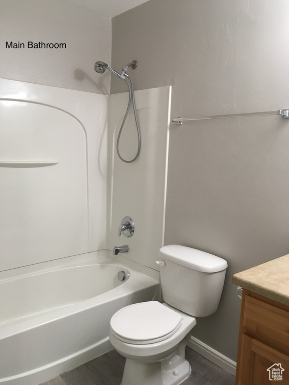 Full bathroom featuring vanity, toilet, shower / bathtub combination, and tile flooring