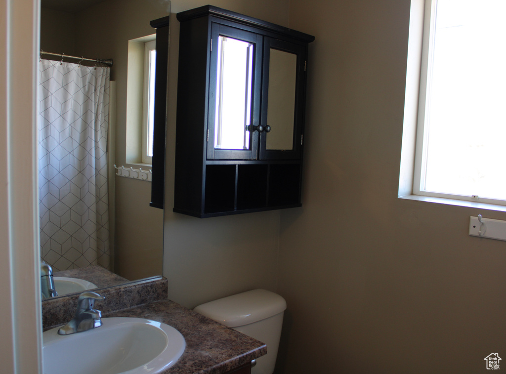 Bathroom with plenty of natural light, vanity, and toilet