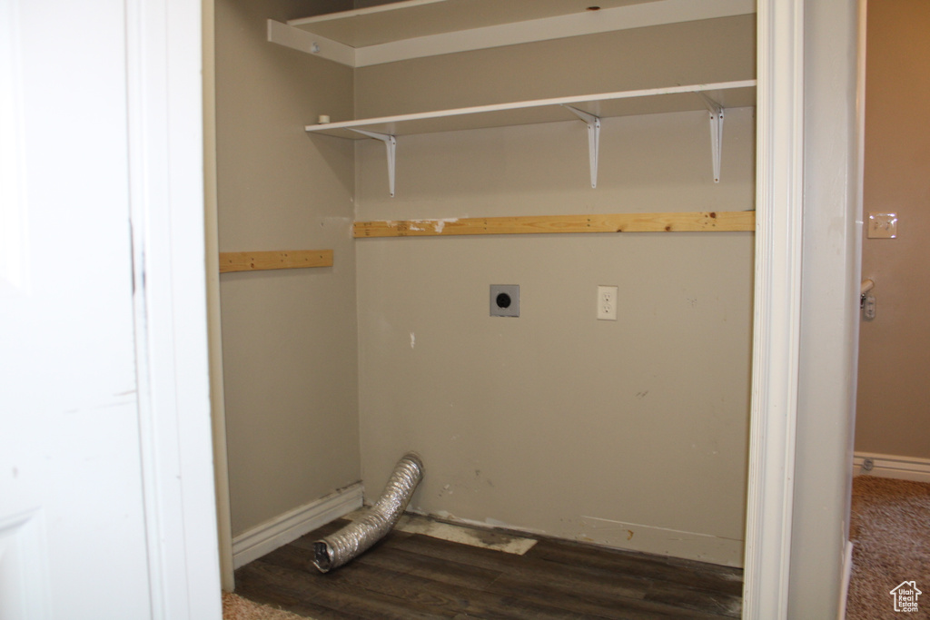 Laundry area with dark hardwood / wood-style flooring and hookup for an electric dryer