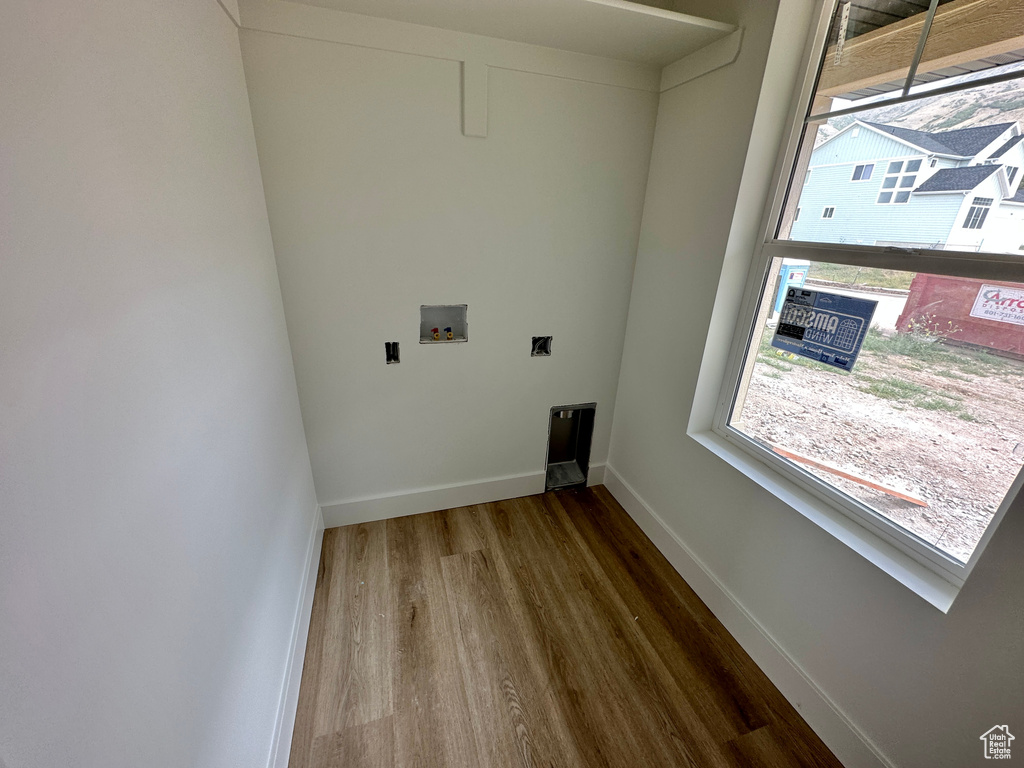 Washroom featuring dark hardwood / wood-style floors and washer hookup