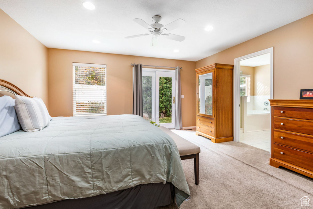 Bedroom with multiple windows, access to outside, ceiling fan, and light colored carpet