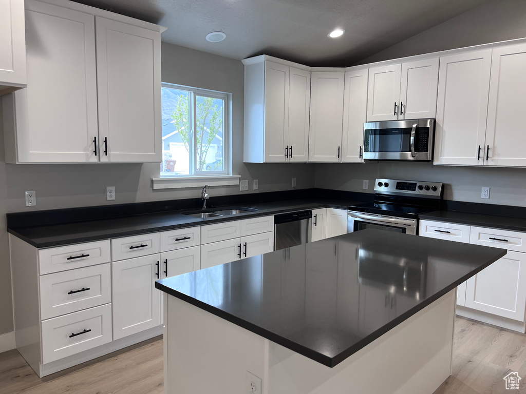 Kitchen featuring white cabinetry, light hardwood / wood-style flooring, stainless steel appliances, and sink