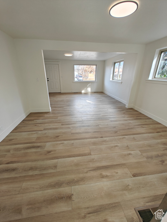 Unfurnished room with a wealth of natural light and light hardwood / wood-style flooring
