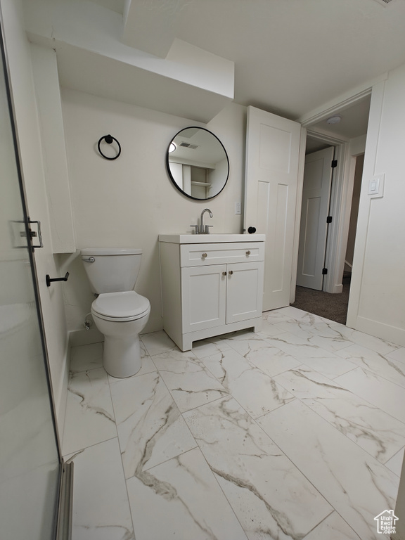 Bathroom with vanity, tile floors, and toilet