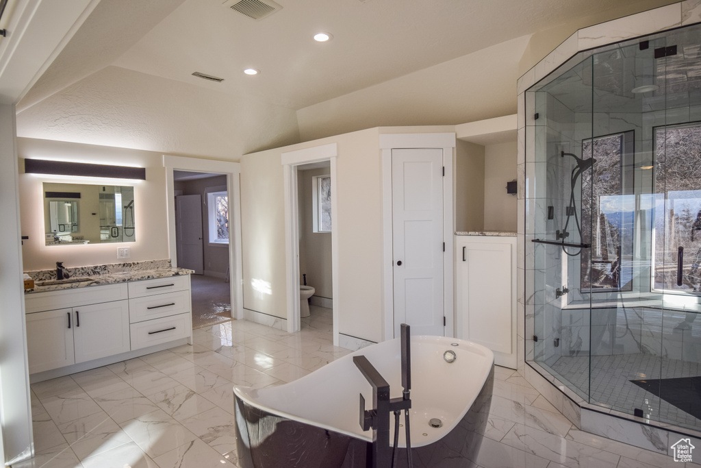 Bathroom with a bidet, vanity, tile flooring, and separate shower and tub