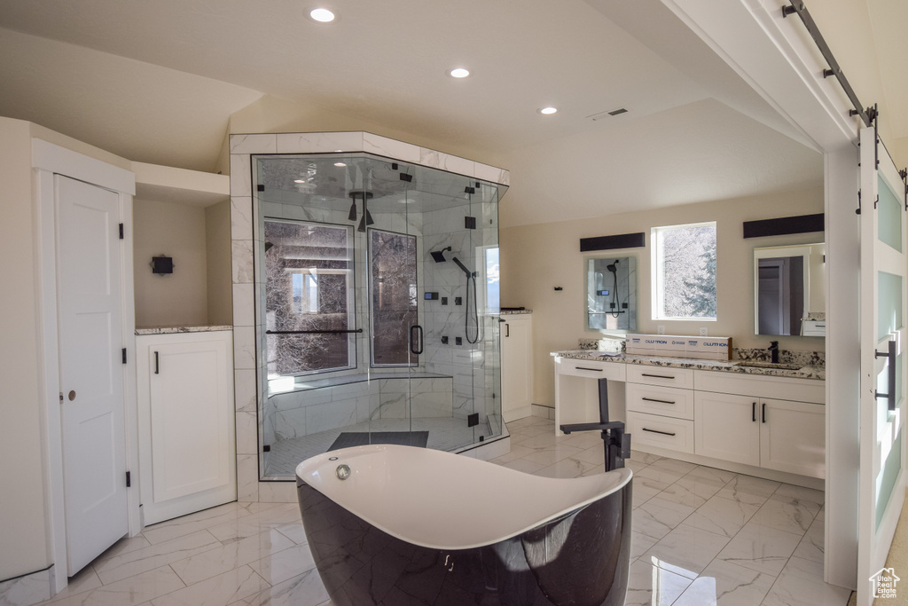 Bathroom with tile floors, oversized vanity, and shower with separate bathtub