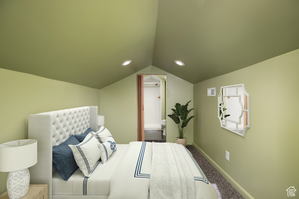 Bedroom with carpet floors, ensuite bathroom, and vaulted ceiling