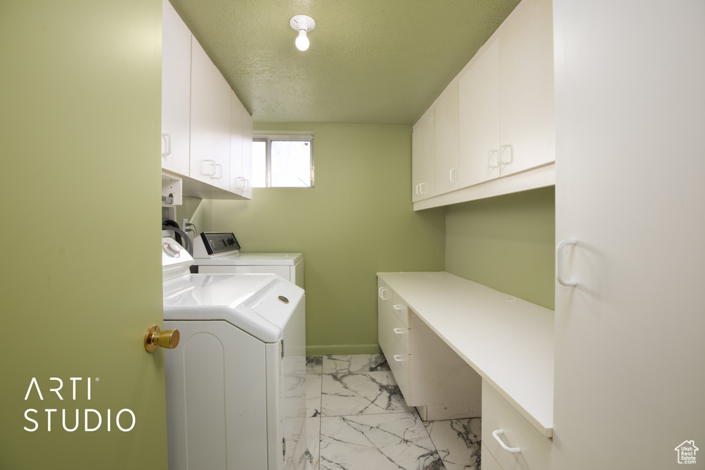 Laundry area featuring washer and dryer, hookup for a washing machine, cabinets, and light tile floors