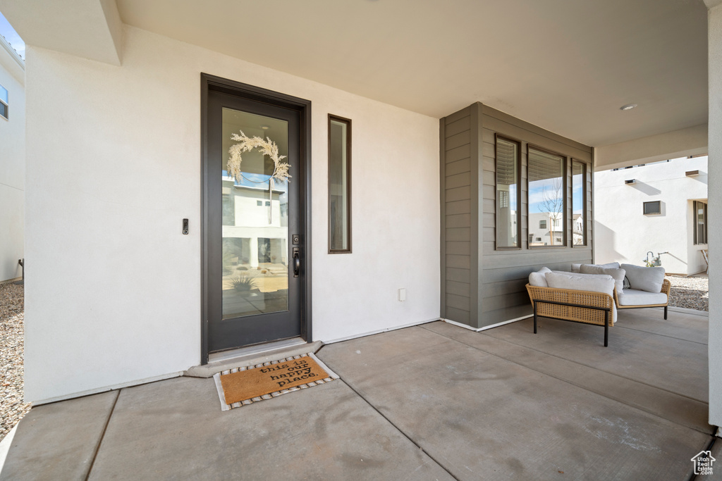 Doorway to property featuring a patio area