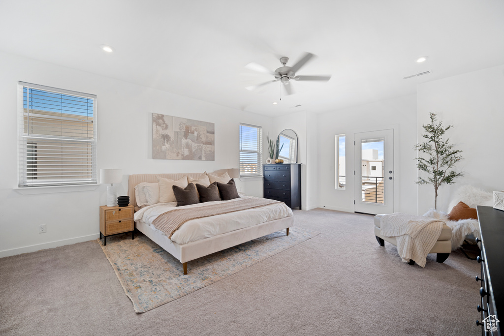 Bedroom featuring light carpet, ceiling fan, and access to exterior