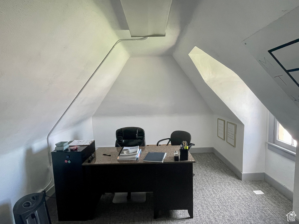 Carpeted office featuring lofted ceiling