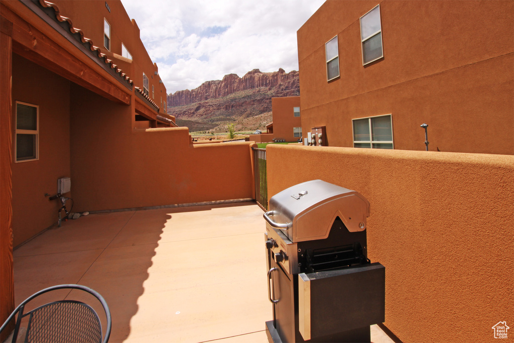 View of patio / terrace featuring a mountain view, area for grilling, and a balcony